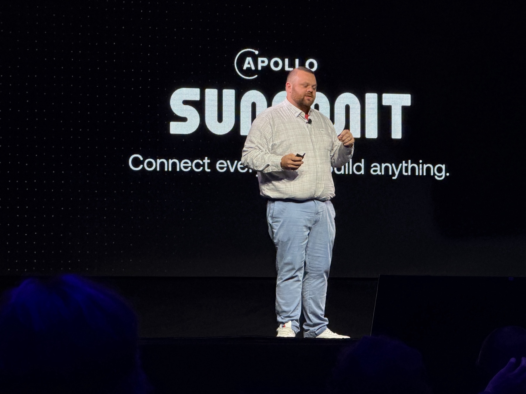 Kenny Hammerlund on stage at Apollo Summit 2026, in front of the Summit screen